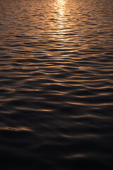 golden sunset reflection in water waves, cinematic golden water waves stock image