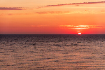 Fototapeta premium Beautiful red and orange sunrise over the sea.