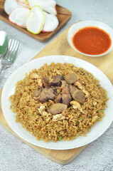 Delicious beef fried rice with egg, chilli, crackers and green onion, Indonesian dish.