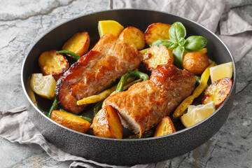 Lemon Garlic Pork Roast with french beans and new Potatoes close-up in a pan on the table. Horizontal
