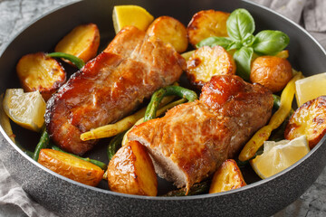 Baked Lemon garlic Pork Tenderloin with french beans and new Potatoes close-up in a pan on the table. Horizontal