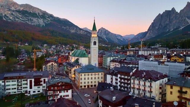 Cortina d Ampezzo in Italian Alps, Winter Olympics in Italy, winter skiing resort in the Dolomites, drone shot of Cortina d Ampezzo in the Italian Alps at sunrise