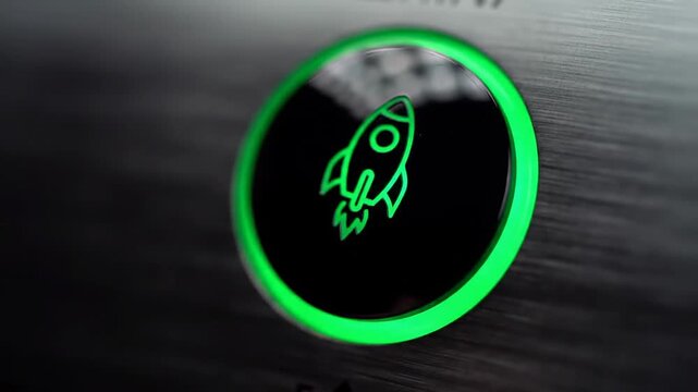 Close Up Finger Pressing Luminous Green Rocket Launch Button on Metallic Surface