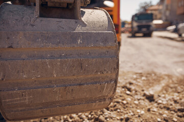 Public city street reconstruction with heavy machines.
