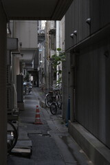Bicycle parked in back alley with houses, Tokyo, Japan