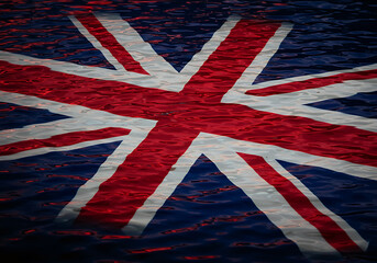Fototapeta premium The Union Jack flag of the United Kingdom is seen with a textured water ripple effect, suggesting it is submerged or reflected on a wavy surface.