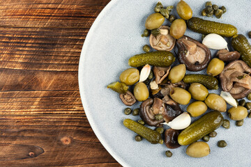 salted cucumbers, marinated mushrooms and olives