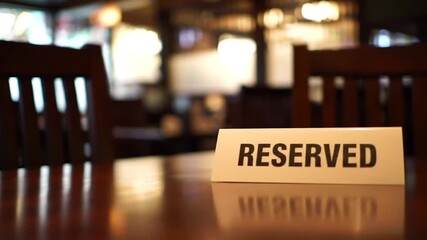 Reserved Table with Brown Wooden Chairs in a Restaurant With Bokeh Lighting