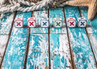 Wooden cubes with X's and checkmarks on a weathered teal wood surface, nautical theme