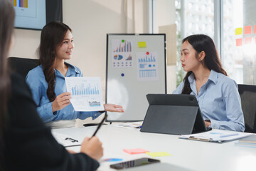 Businesswomen discussing charts and graphs during office meeting