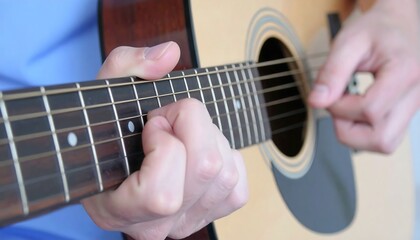 Fototapeta premium Close-up of hands playing acoustic guitar