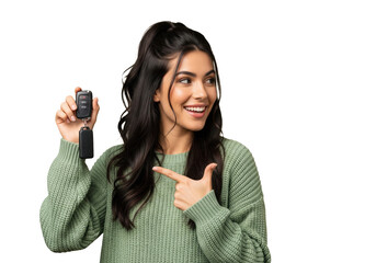 Happy woman holding and pointing to car keys isolated on a transparent background

