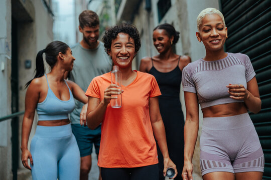 Group of diverse athletes walking and talking after workout