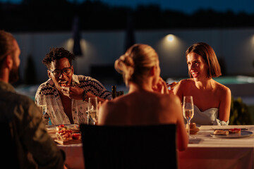 Friends Enjoying Dinner Outdoors at Night