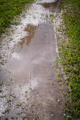 Flooded muddy rural path after heavy rain on summer day