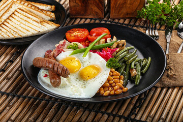 Traditional Engrlish breakfast with egg  and sausages
