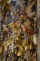 Seville, Spain 03.25.2019: Golden decoration with figures behind the altar of El Divino Salvador church in Seville