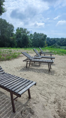 Summer river landscape with green trees, reflections and blue sky. Tourism