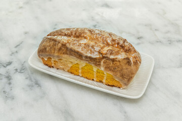 Sicilian lemon sponge cake with homemade lemon curd filling and citrus zest decoration Fresh