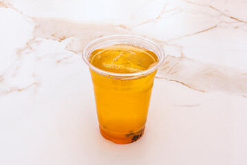 Summer classic: Freshly brewed iced tea with a touch of honey, served in a frosted, condensation-covered glass that invites you to sip