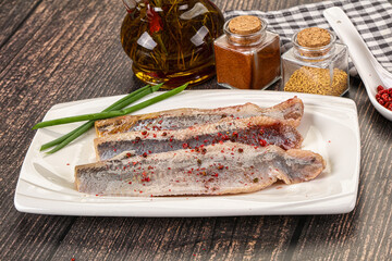 Salted marinated herring fillet with spices