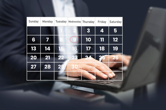 Time management concept. Calendar screen application with laptop. People manage time for effective work. Make an appointment, action plans, highlight reminders, and meeting agenda on the calendar. 