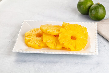 Sweet canned pineapple slices in syrope