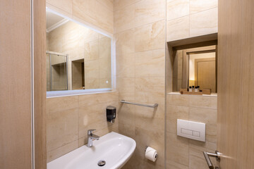 Interior of a hotel bathroom with a  mirror
