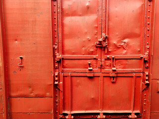 Orange colour compartment door of a goods train load unloader. locked indian boogie