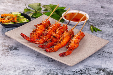 Grilled prawn skewer served sauce