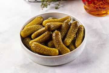 Marinated canned green cornichon cucumbers