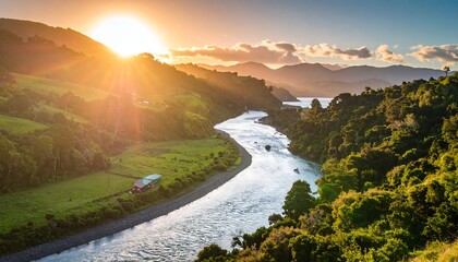 River bends through lush green valley at sunset, sun shining brightly