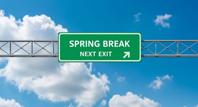 Spring Break Highway Sign Against a Blue Sky with Clouds, Indicating Upcoming Travel and Vacation