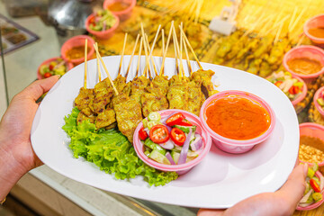 Grilled chicken wings and shish kebabs served on skewers with a delicious meal presentation