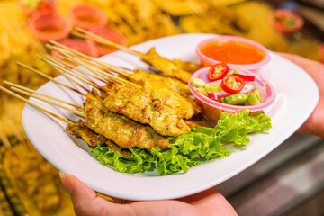 Grilled chicken wings and shish kebabs served on skewers with a delicious meal presentation
