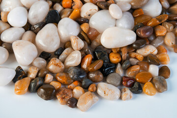 A variety of small stones of different geological origins on white background.