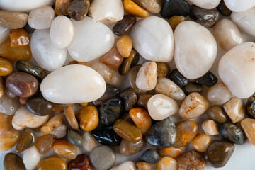 Colorful small stones sea pebbles backgroundม A variety of small stones of different geological origins.