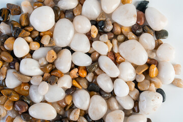 A variety of small stones of different geological origins on white background.