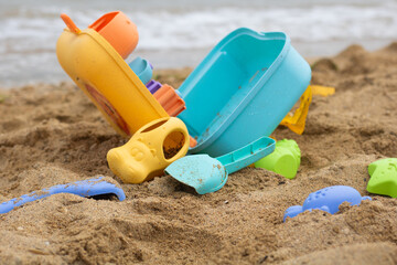 Colorful beach toys on sandy shore