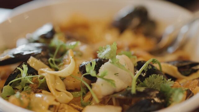 Close-Up of Steaming Seafood Chowder With Fresh Herbs