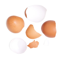 Top view broken eggshells stacked on white background.