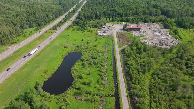 Aerial over industrial dock fabrication shop near Highway 11 in Muskoka