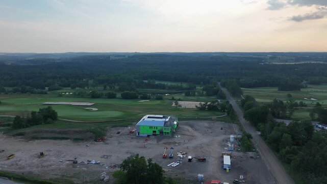 Aerial: Golf Canada headquarters construction site at TPC Toronto at Osprey Valley golf course in Alton, Caledon, Ontario, Canada, orbit drone shot