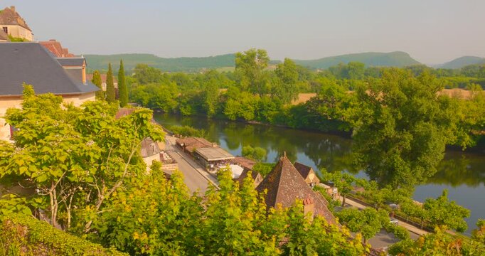 Dordogne River With Lush Green Trees In Beynac, France. - wide shot