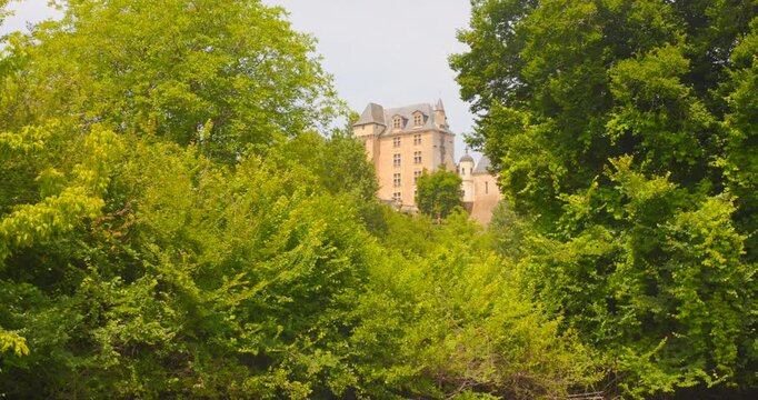 Discover the stunning Fayrac castle positioned majestically near Beynac, France. This aerial view showcases the castle's architecture amid vibrant green landscapes, creating a serene mood.