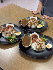 steamed rice topped with chicken On the table