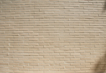 Small brick wall background, beige brick texture and masonry pattern, ideal for construction, architecture, and decorative design projects. this building wall with clean brick surface.