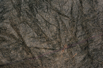 Old black plastic canvas with a rough surface