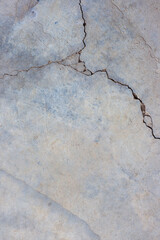 Close-up of cracked and rough concrete for overlay background.