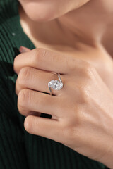 Elegant silver engagement ring with a large round-cut diamond, beautifully displayed on a woman’s hand.